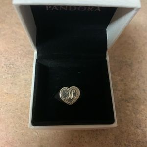 Pandora M ring with studs around it.